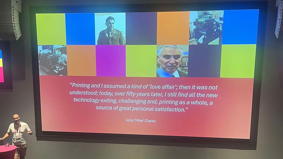 Nigel Clarke showing the audience a quote from his grandfather about working in print