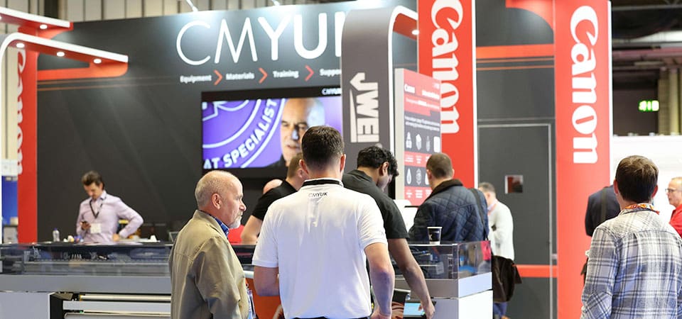 The CMYUK with Canon and JWEI branding in grey and red at The Print Show