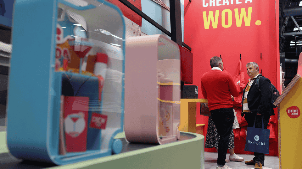 A customer speaking to a staff member on the Print.com stand at The Print Show 2024