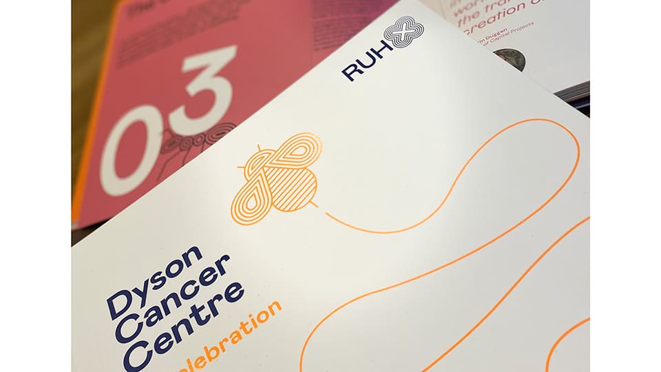 The Dyson Cancer Centre celebration book with a bumble bee illustration