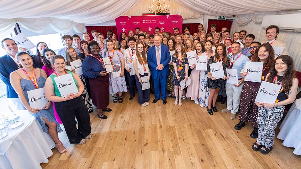The 2026 winners who attended the Rising Star Awards along with Printing Charity president emeritus, Lord Black of Brentwood [pictured centre]